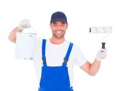Portrait of smiling handyman with paint can and roller on white backgr